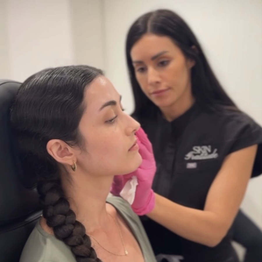 nicole sandoval performing a lip treatment